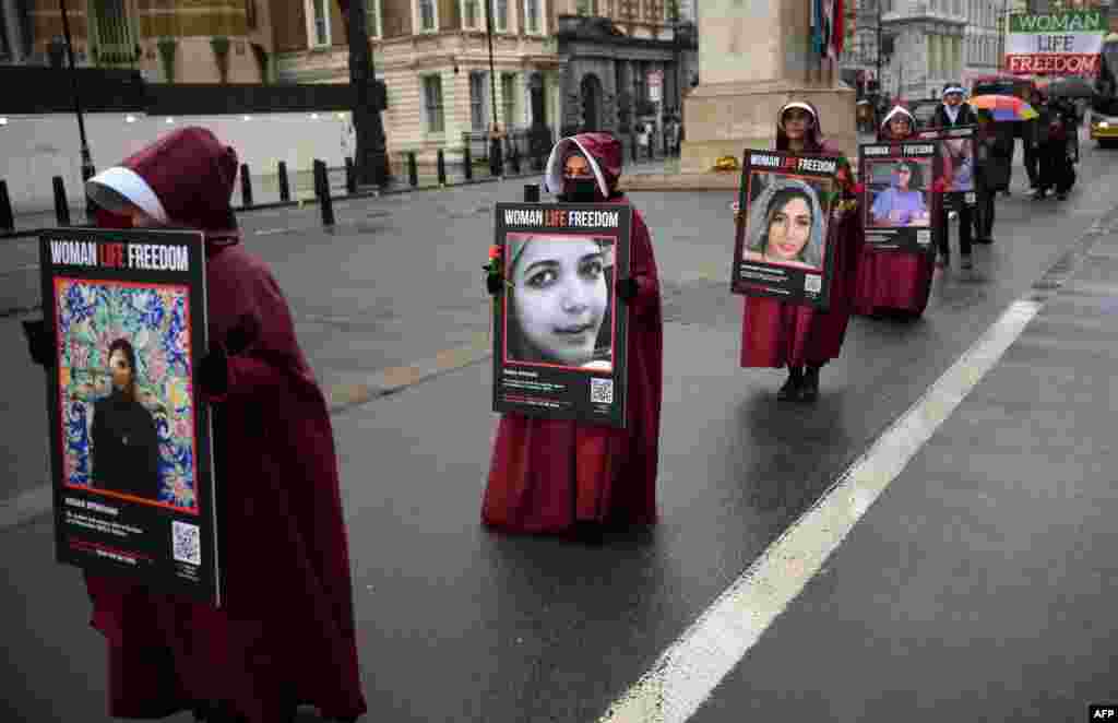 Demonstrators hold placards reading &quot;&quot;Women, Life, Freedom&quot;&nbsp;on Whitehall in central London as they demonstrate against the persecution of women in Iran.
