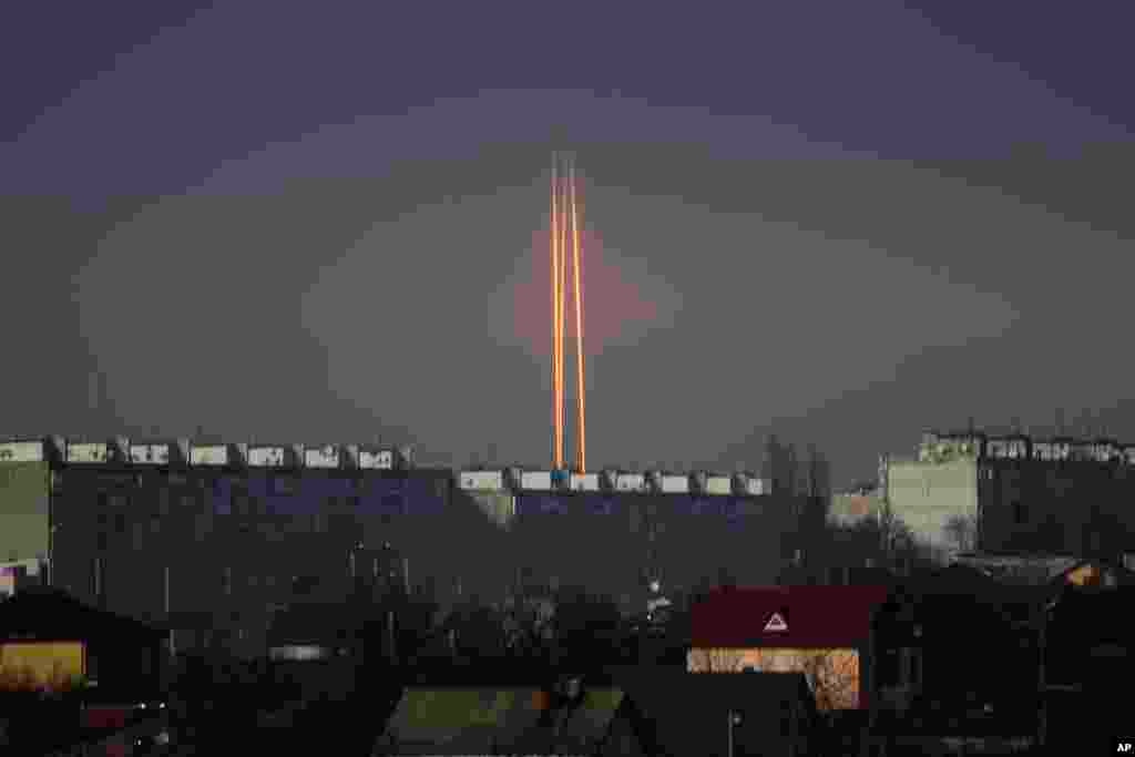 Three rockets launched against Ukraine from Russia&#39;s Belgorod region are seen at dawn in Kharkiv, Ukraine.
