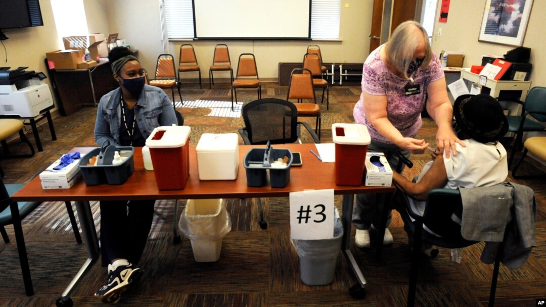 Officials say, the vaccine campaign in Tuskegee, Alabama is off to a slow start. Here nurse Marianne Williams gives a COVID-19 vaccine to a woman at the county health department in Tuskegee, Alabama on January 25, 2021. (AP Photo)
