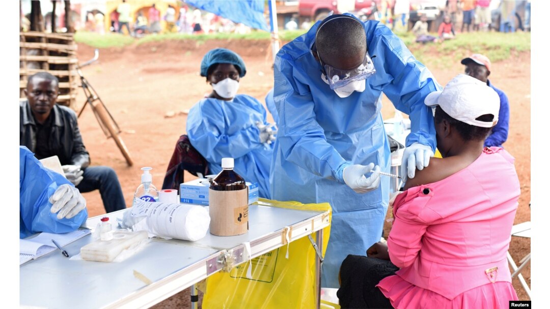 FILE - A Congolese health worker administers Ebola vaccine to a woman who had contact with an Ebola sufferer in the Democratic Republic of Congo, Aug. 18, 2018.