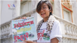Rithy Lomorpich holding Bonn Phum Banner