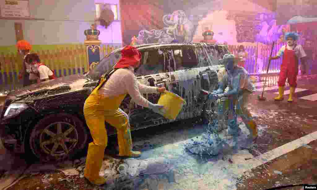 Clowns of the circus Krone joke around in the circus&#39; own car wash to bring joy to the people, as the circus is not allowed to perform due to the coronavirus disease (COVID-19) outbreak, in Munich, Germany.