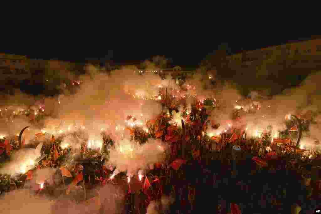 Protesters light torches during a rally in Podgorica, Montenegro, Sept. 6, 2020.&nbsp;Several thousand protesters waving Montenegro flags have gathered in the state capital in support of the ruling pro-Western party.