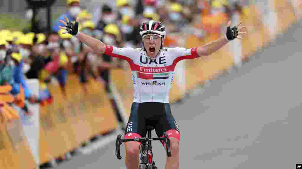 Slovenia&#39;s Tadej Pogacar crosses the finish line to win the ninth stage of the Tour de France cycling race over 153 kilometers (95 miles), with start in Pau and finish in Laruns, France.
