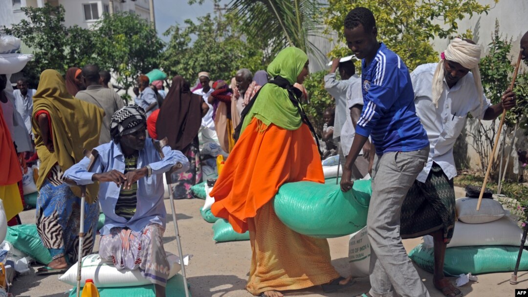 FILE - Somali internally displaced people receive food aid donated by a Qatari charity during the holy Muslim month of Ramadan in Mogadishu, June 20, 2015. Somalia's federal government has said it will stay neutral in Qatar's dispute with other Gulf Arab states.