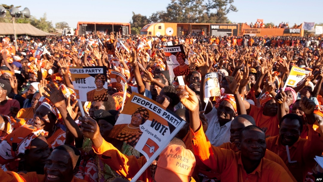 Supporters of Malawi's incumbent President cheer during her final campaign rally at Songani village on the outskirts of the city of Zomba, the former capital of Malawi, May 17, 2014.