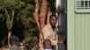 Zimbabwean journalist Blessed Mhlanga (C) climbs into a Zimbabwe Prison vehicle in Harare on February 27, 2025 after his bail ruling was postponed by a day.