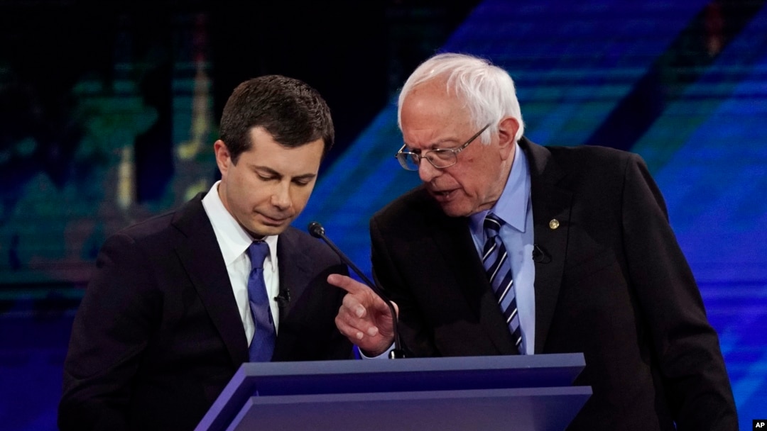 Democratic presidential candidates South Bend Mayor Pete Buttigieg, left, and Sen. Bernie Sanders talk during a break, Sept. 12, 2019, during a Democratic presidential primary debate in Houston.