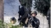 Israeli soldiers stand guard during an army raid in the Palestinian village of Qabatiyah, in the north of the occupied West Bank, Jan. 10, 2025. 