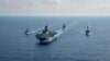 Royal Australian Navy guided-missile frigate HMAS Parramatta (FFH 154) (L) sails with U.S. Navy Amphibious assault ship USS America (LHA 6), Ticonderoga-class guided-missile cruiser USS Bunker Hill (CG 52) and Arleigh-Burke class guided missile destroyer.